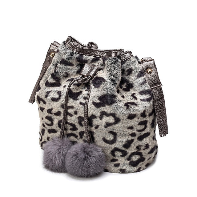 Light grey leopard-print faux-fur drawstring bucket bag with tassels and pom-poms