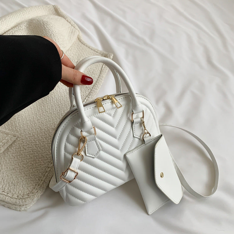 White quilted shoulder messenger bag with gold hardware, top handle and front flap
