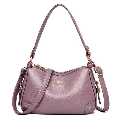 Women’s one-shoulder messenger bag in mauve soft leather with gold-tone hardware.