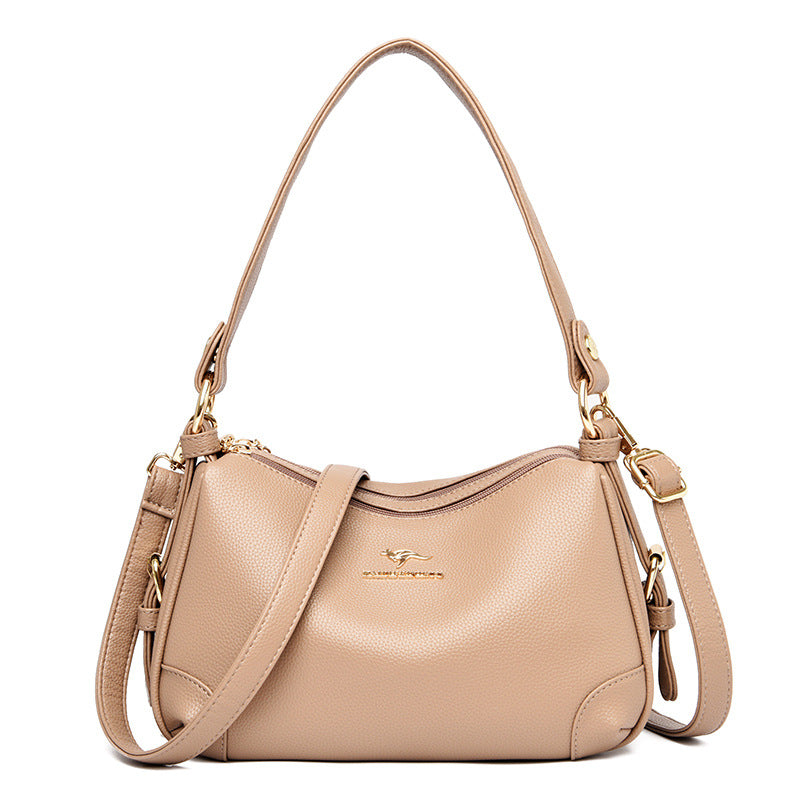 Women’s one-shoulder messenger bag in beige soft leather with gold-tone hardware.