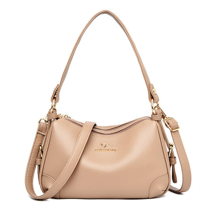 Women’s one-shoulder messenger bag in beige soft leather with gold-tone hardware.