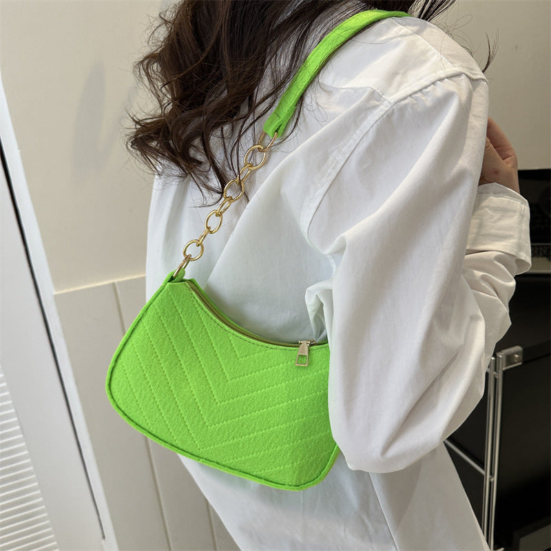 Neon green felt crossbody bag with gold chain strap and front quilted panel