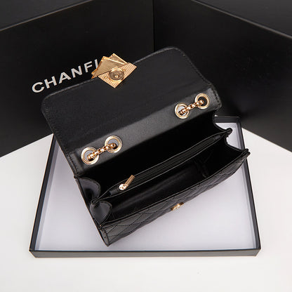 Black mini square crossbody bag with quilted pattern, gold chain, and front clasp
