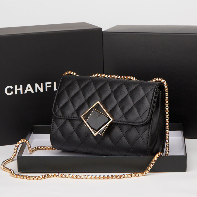 Black quilted mini square crossbody bag with gold chain and diamond-shaped clasp