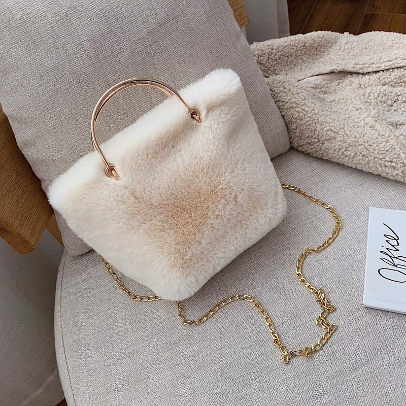 White plush mini shoulder bag with gold chain strap and copper hoop handle