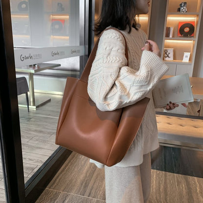 Brown large-capacity tote handbag with two top handles and structured, flat base