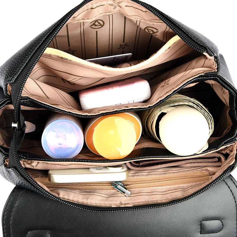 Black women’s handbag open interior with zip lining and multiple small pockets