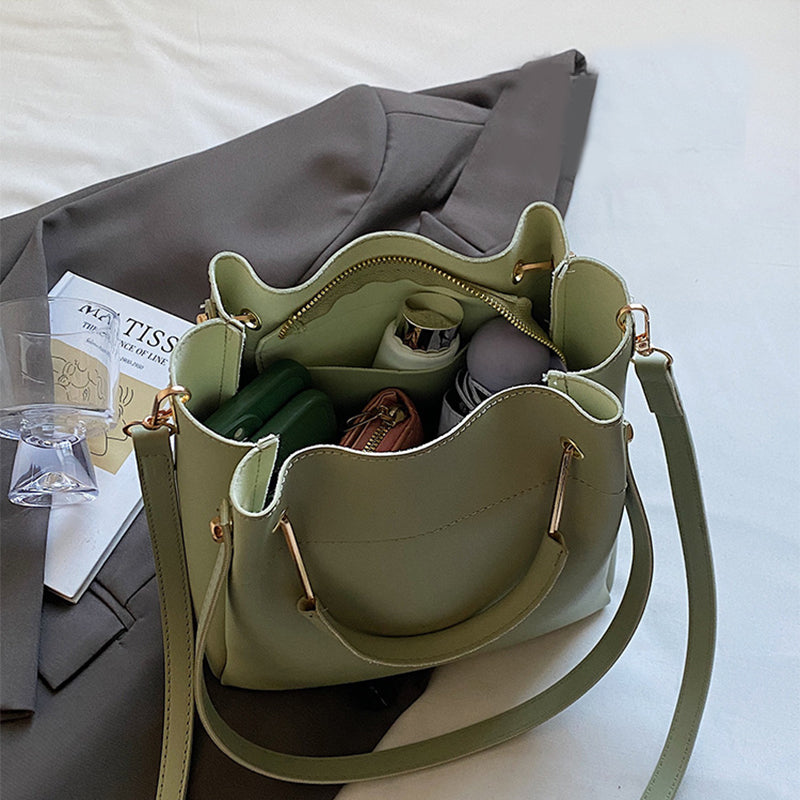 Olive green bucket bag with open top showing inner compartments and drawstring cord
