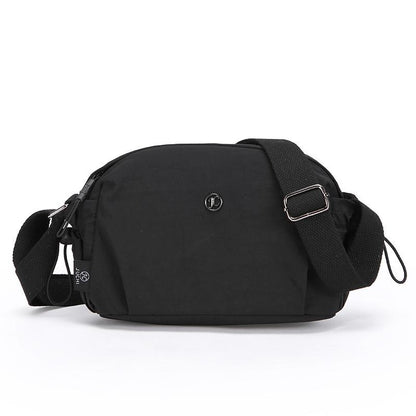 Black nylon crossbody bag with front logo and adjustable shoulder strap, zip closure