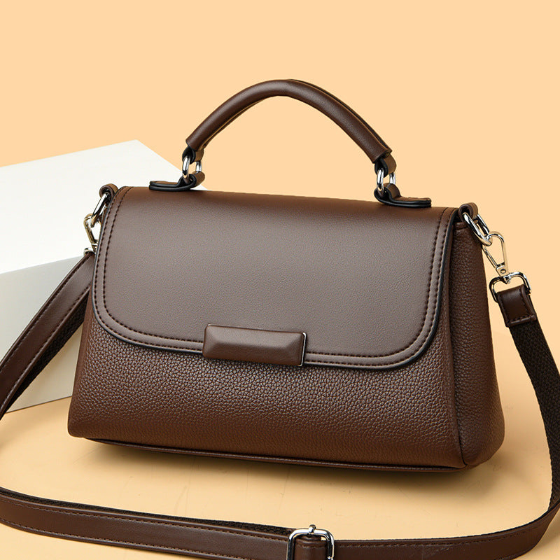 Women’s flap handbag in brown textured finish with top handles and crossbody strap