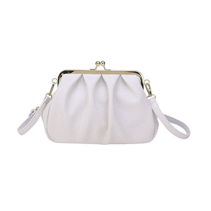 White textured clutch-style handbag with kiss-lock frame and side straps