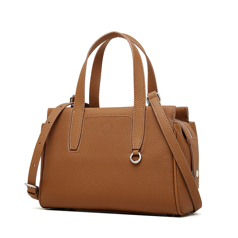 Brown crossbody bag with top handles, adjustable shoulder strap, and front pocket