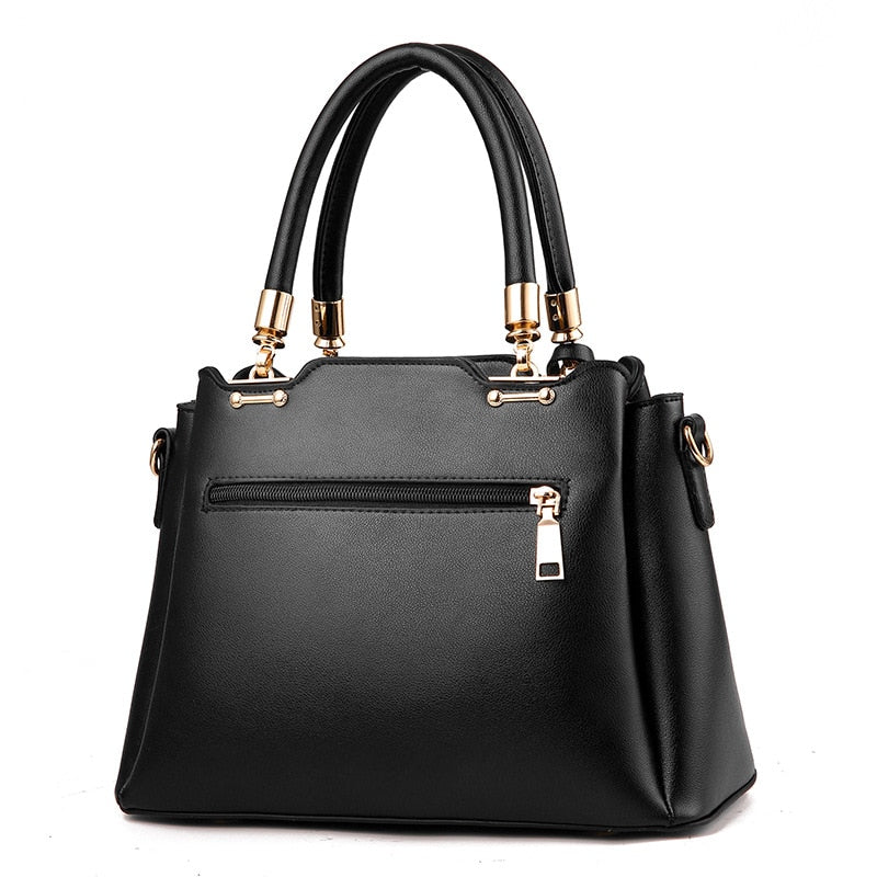 Black women’s handbag with top handles, front zipper pocket, and crossbody strap
