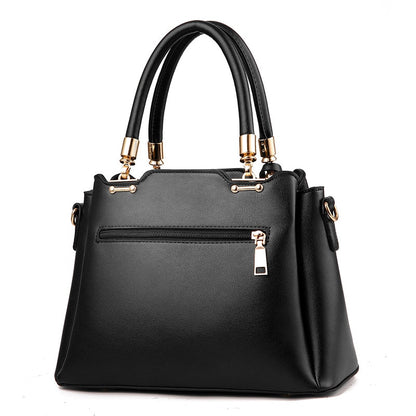 Black women’s handbag with top handles, front zipper pocket, and crossbody strap