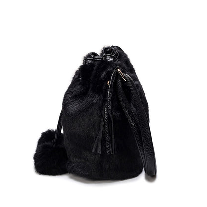 Black faux-fur drawstring bucket bag with tassels and hanging key charm