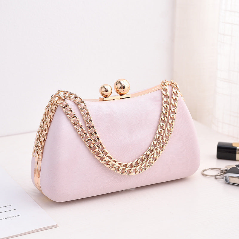 Pink textured clutch bag with gold-tone chain shoulder strap and kiss-lock clasp