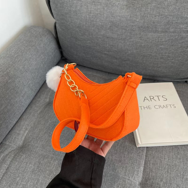 Orange felt crossbody bag with gold chain strap and front flap