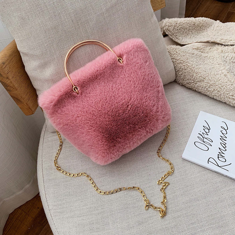 Pink plush mini shoulder bag with gold chain strap and copper hoop handle
