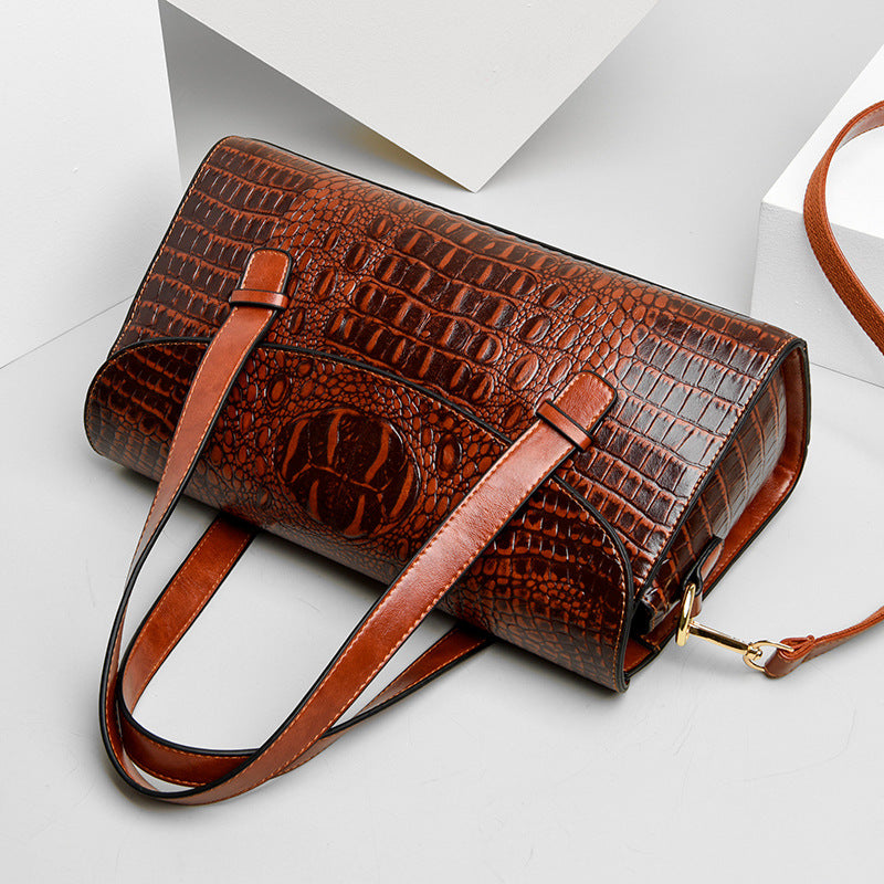 Rust brown croc-pattern shoulder bag with front flap, top handle, and crossbody strap