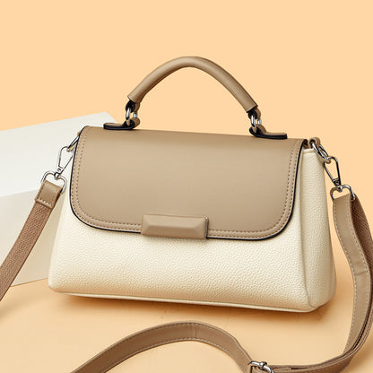 Beige women’s structured flap handbag with top handle and side shoulder straps