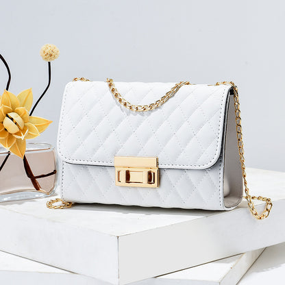 White quilted mini square crossbody bag with gold chain and front turn-lock