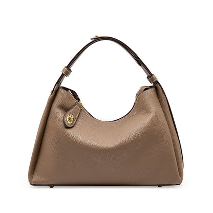 Beige hobo crossbody shoulder bag with curved handles and gold front snap clasp