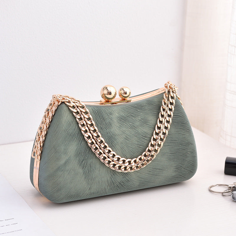 Green textured clutch bag with gold-tone chain shoulder strap and kiss-lock clasp
