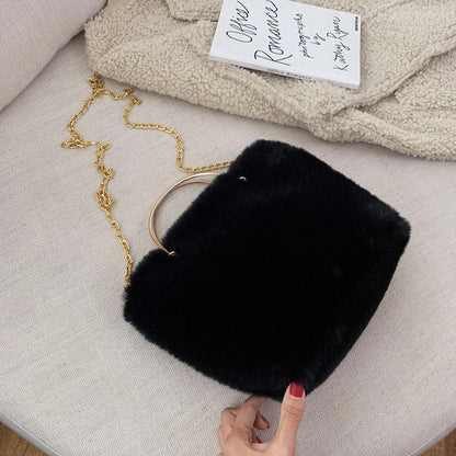 Black plush shoulder bag with gold chain strap and copper hoop handle, mini