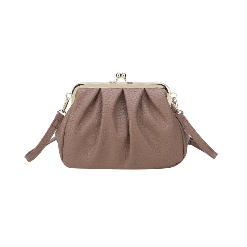 Taupe textured clutch-style handbag with kiss-lock frame and side straps