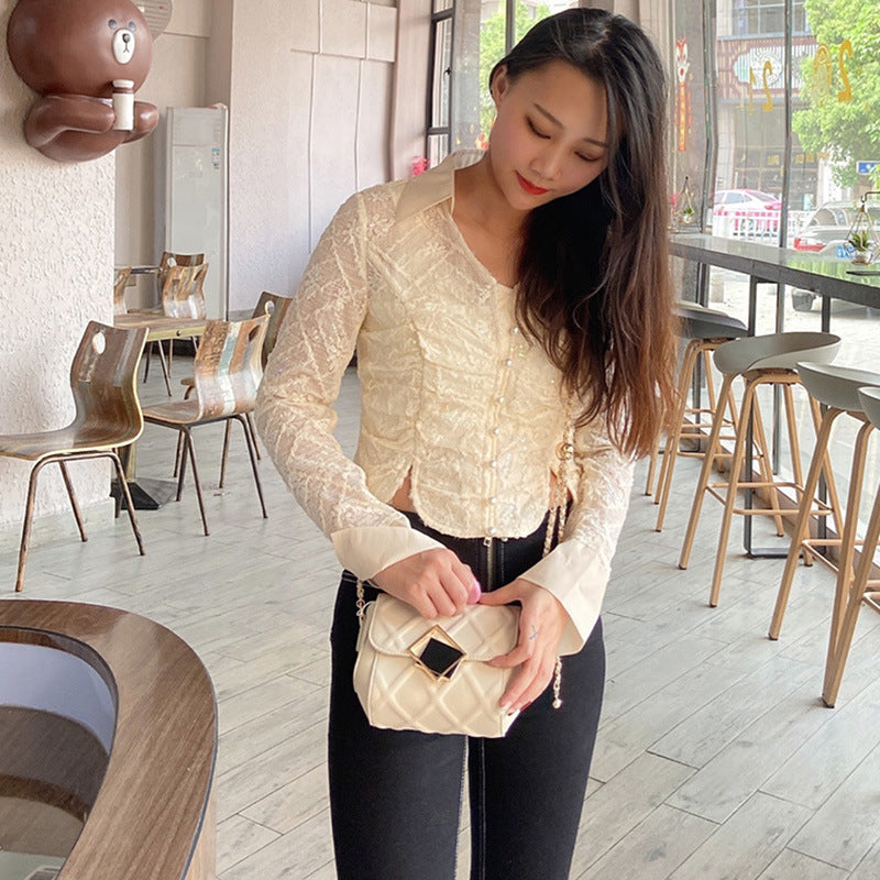 White leather crossbody bag with chain strap and square front emblem