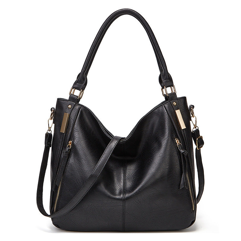 Black leather-look hobo tote with top handles and zippered exterior pockets