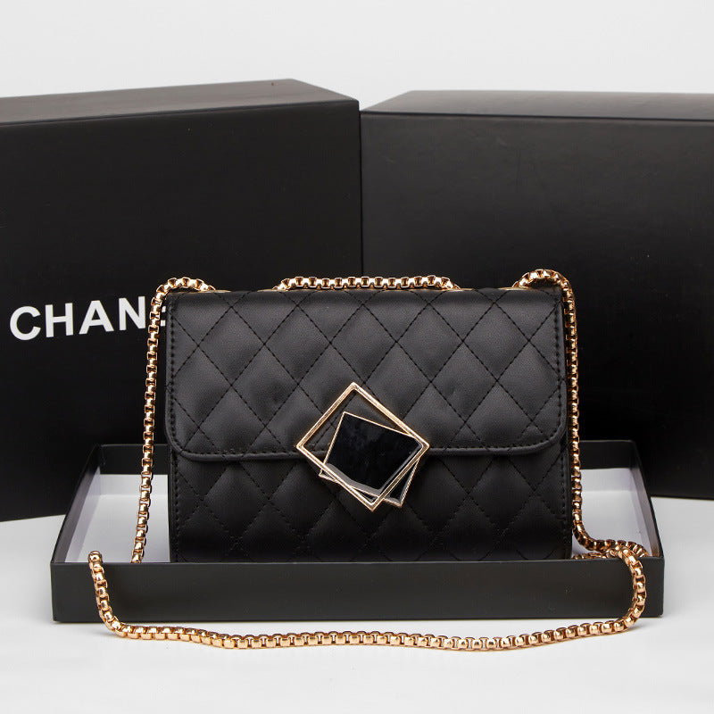 Black quilted mini square crossbody bag with gold chain and diamond-shaped clasp