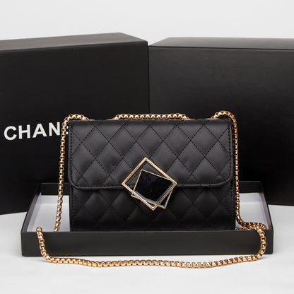 Black quilted mini square crossbody bag with gold chain and diamond-shaped clasp