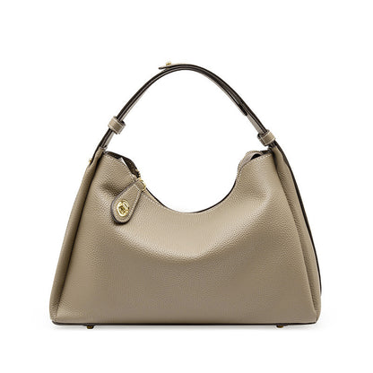 Beige hobo crossbody shoulder bag with curved handle and gold-tone front clasp