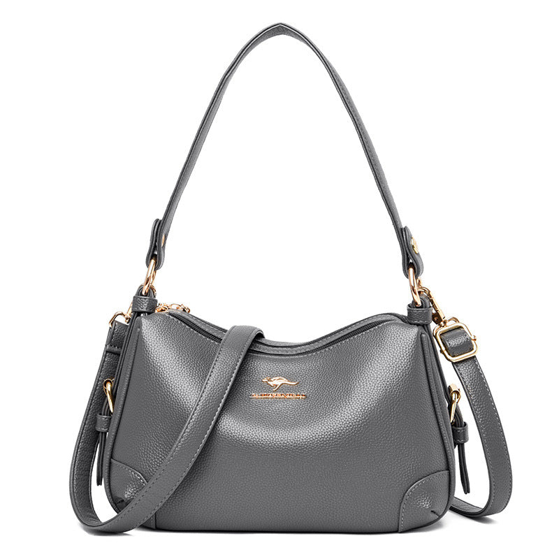 Women’s one-shoulder messenger bag in gray soft leather with gold-tone hardware.
