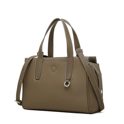 Taupe leather crossbody bag with double top handles, adjustable strap, and front pocket