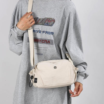 Small off-white nylon crossbody bag with adjustable strap and zip closure