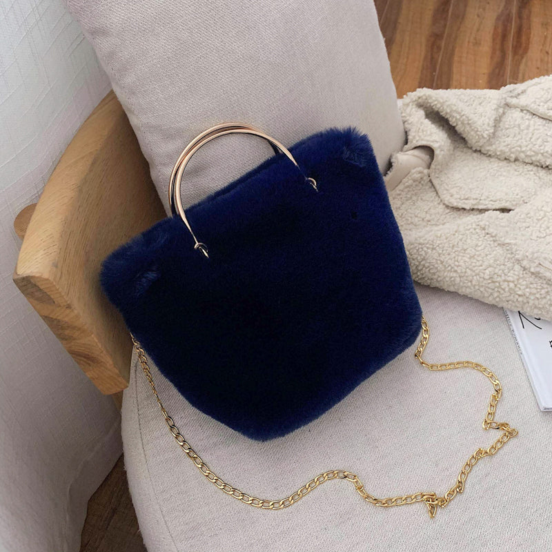 Blue plush mini shoulder bag with gold chain strap and copper hoop handle