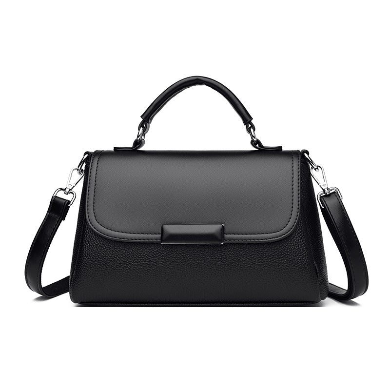 Black women’s flap handbag with top handle, buckle detail, and shoulder strap