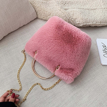 Pink plush shoulder bag with gold chain strap and copper hoop handle, mini size