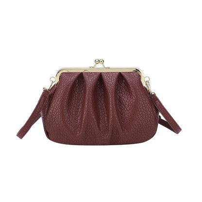 Burgundy textured clutch-style handbag with kiss-lock frame and side straps