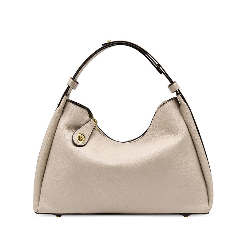 Beige pebbled leather-style crossbody hobo bag with side snap pocket and handles