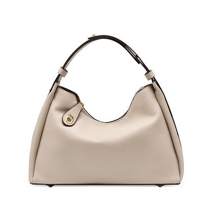 Beige pebbled leather-style crossbody hobo bag with side snap pocket and handles