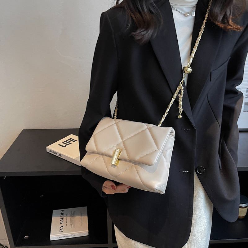 Off-white quilted diamond messenger bag with gold chain strap and front bar lock