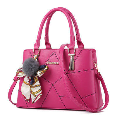 Pink quilted top-handle handbag with adjustable crossbody strap and charm detail