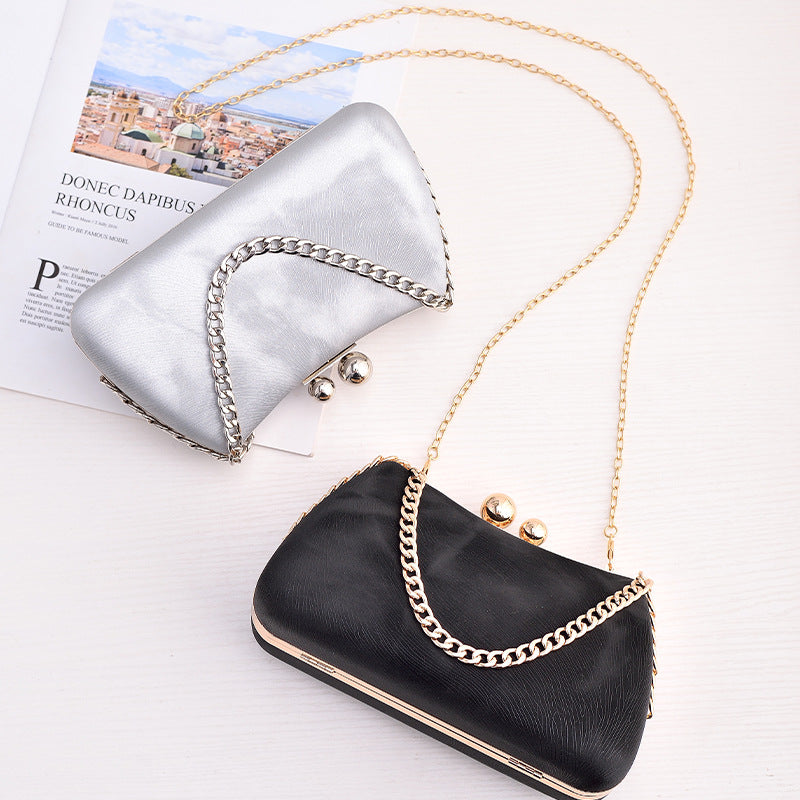 Silver and black chain clutch bags with gold-tone straps and kiss-lock clasps