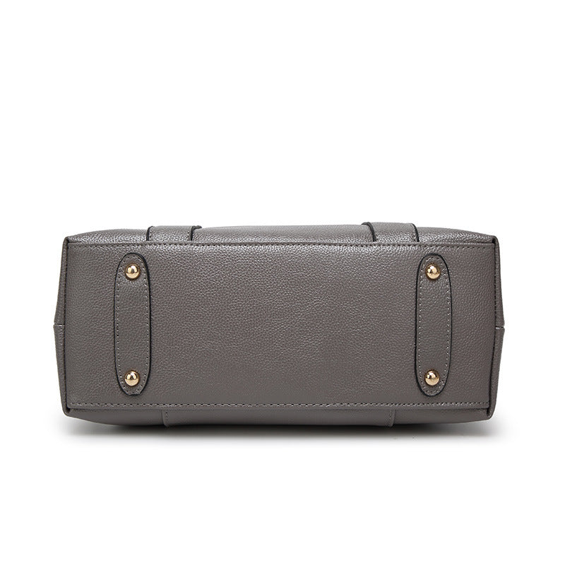 Dark grey structured handbag with top handle and front pocket panel with stud tabs