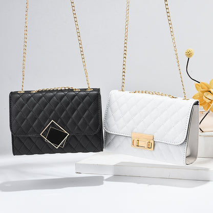 Black and white quilted mini square crossbody bags with gold chains and front clasps