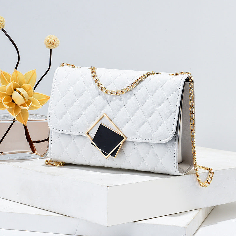 White quilted mini square crossbody bag with gold chain and diamond front clasp
