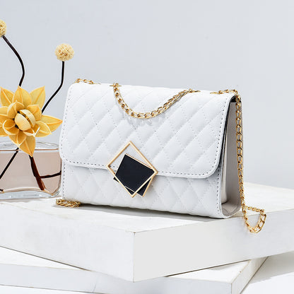 White quilted mini square crossbody bag with gold chain and diamond front clasp